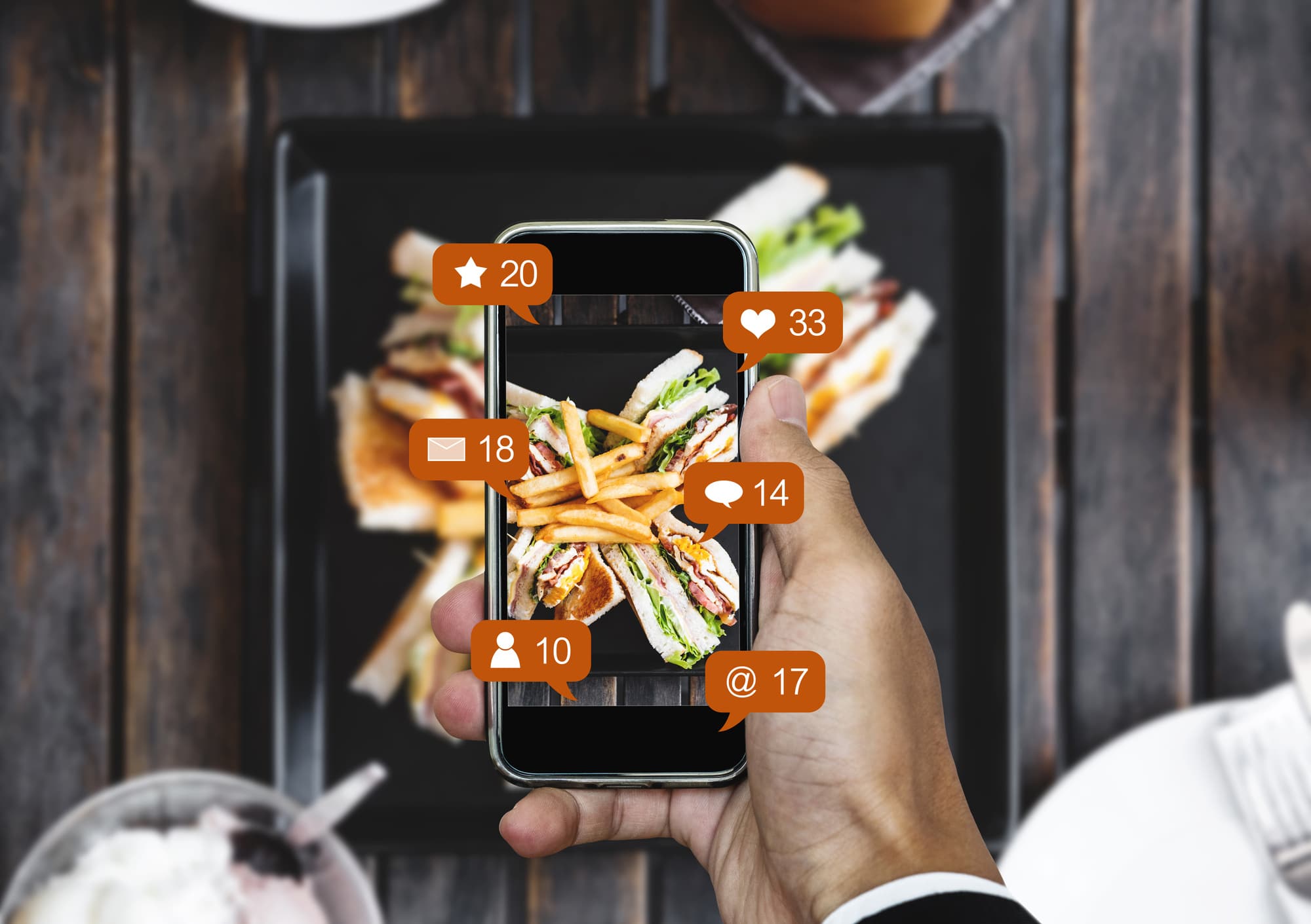 social media icons on mobile phone at restaurant